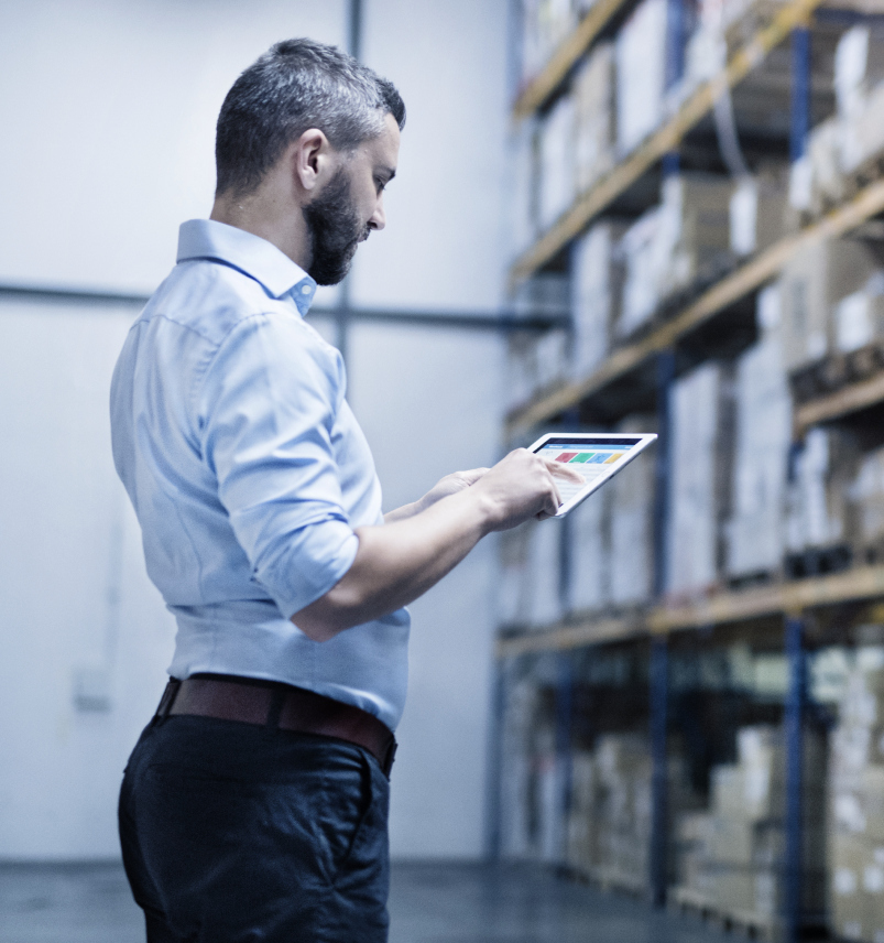 man doing inventory on a tablet